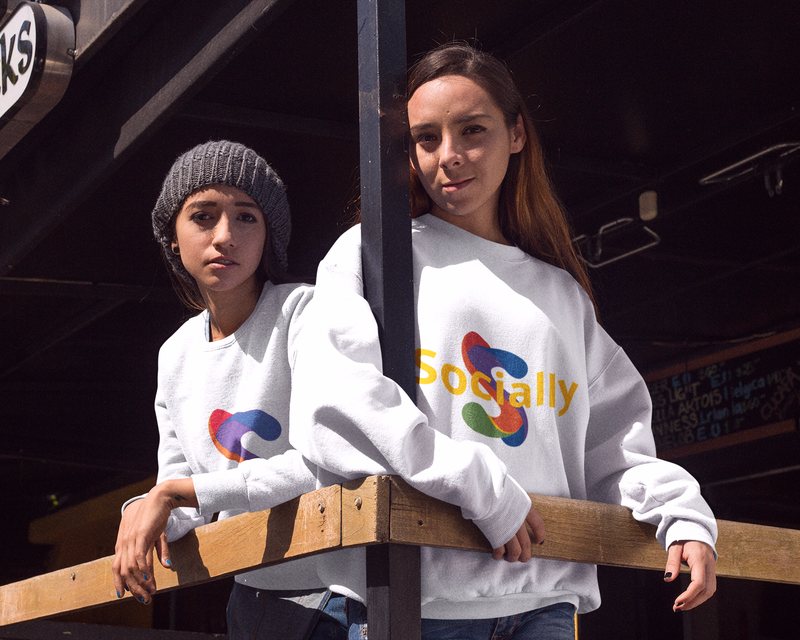 Two friends hanging out together on a bar terrace in Socially sweatshirts