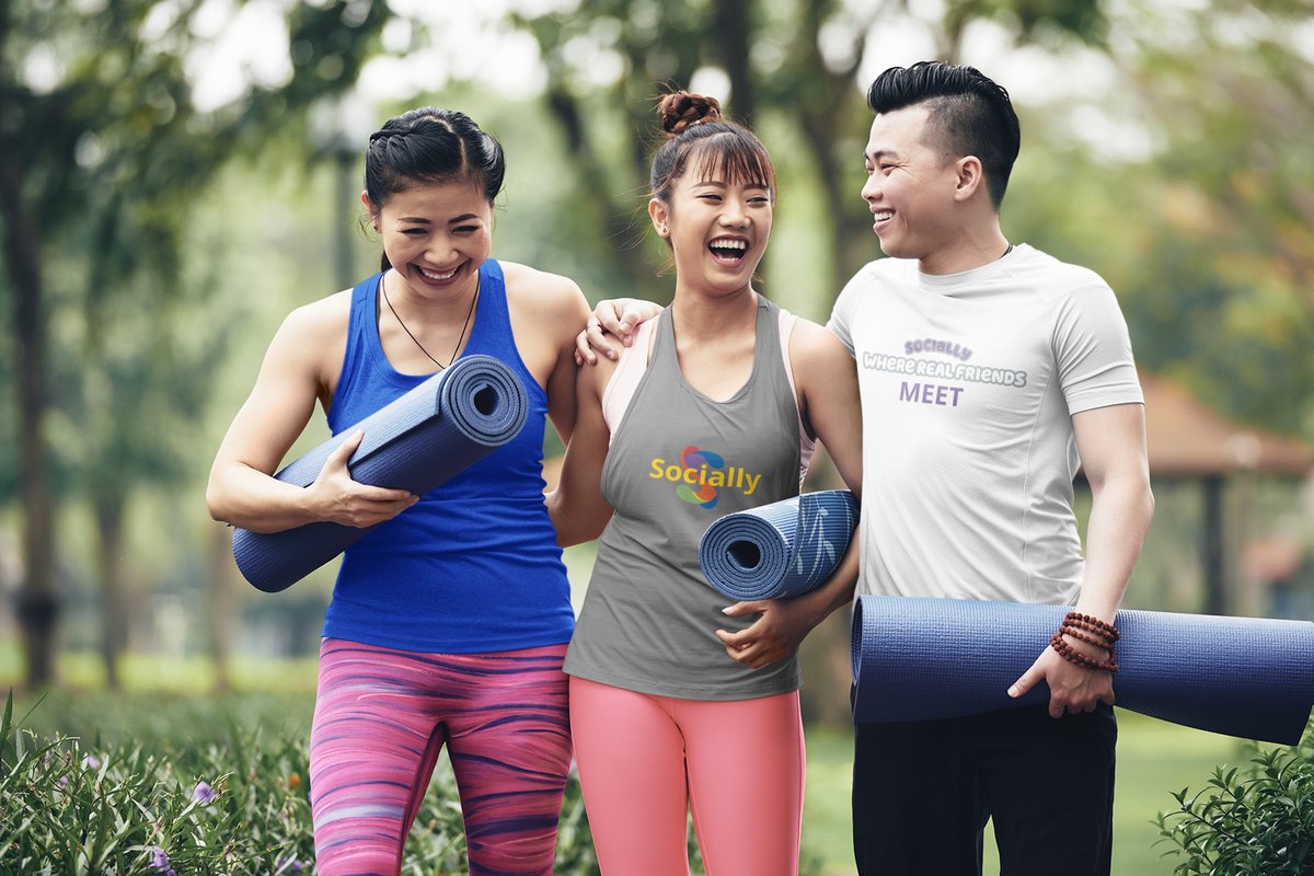 Three friends walking together with yoga mats, one wearing a Socially tee